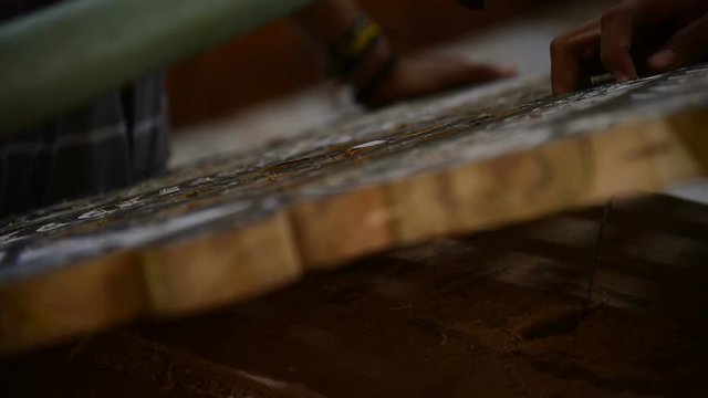 Woodcarving basic shapes to wooden board for later finishing the carvings by hand
