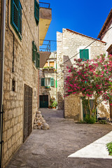 Fototapeta na wymiar Narrow old streets and yards in Sibenik city, Croatia, medieval zone