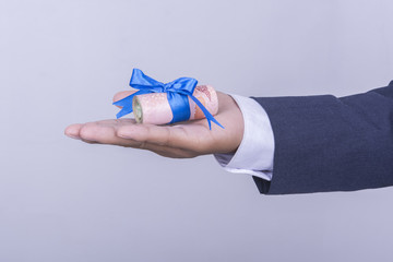 Money with ribbon in businessman hand