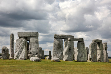 Fototapeta na wymiar Stonehenge historic site on green grass under blue sky. Stonehen