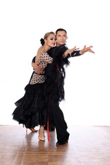 Latino dancers in ballroom against white background