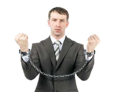 Business man wearing suit in handcuffs
