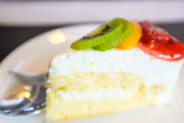Cheese cake and mix fruits on white dish