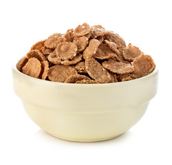 Bowl with grain cereal flakes on the white background.
