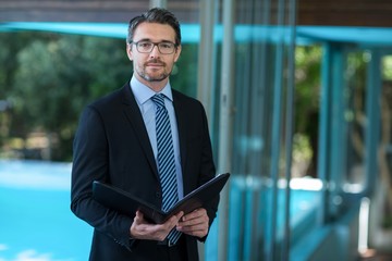 Fototapeta premium Businessman in suit holding folder