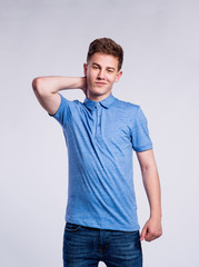 Boy in jeans and t-shirt, young man, studio shot
