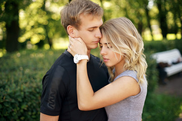 Romantic couple hugging in park on a summer day