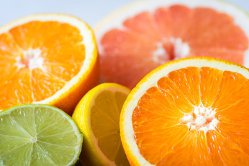 Close shot of various citrus fruits. Grapefruits, oranges, limes, lemons. Macro view. Selective focus.