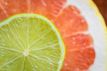 Macro shot of various citrus fruits. Grapefruits, limes. Horizontal view. Selective focus.