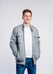 Boy in jeans and jacket, young man, studio shot