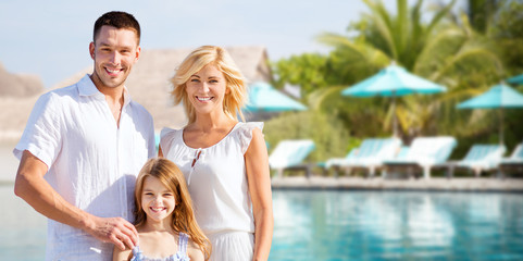 happy family over hotel resort swimming pool