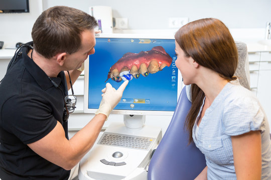 Dentist counseling a patient about CEREC dental technology
