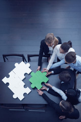 Business people assembling puzzle