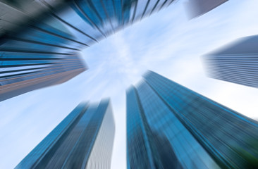 Fototapeta na wymiar look up modern office building in cloud sky