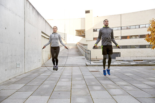 man and woman exercising with jump-rope outdoors