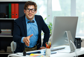 Modern business man with arm extended to handshake