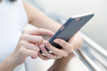 Woman sending text message on mobile phone