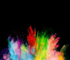 Explosion of colored powder on black background
