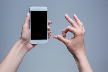 Closeup shot of a woman typing on mobile phone 