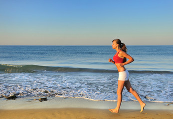 Beautiful girl running on beach at morning
