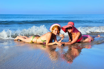 Beautiful girls resting at the sea