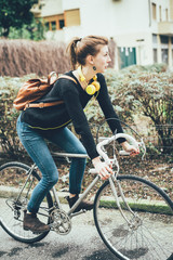 Young beautiful hipster sporty blonde woman riding a bike outdoor in the city - sportive, transport concept