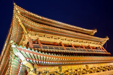 Tuinposter The illuminated ancient Drum Tower located at the ancient city wall by night time, Xian, Shanxi Province, China © MediaNation.online