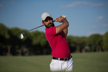 golfer hitting a sand bunker shot