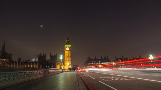 Big Ben time-lapse on the Westminster Bridge in London at Night with the Moon.
Long shutter speed with long light trails.
