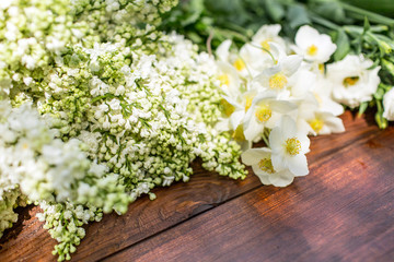 White flowers on a wooden table.