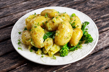 Young boiled potatoes with butter and vegetables.