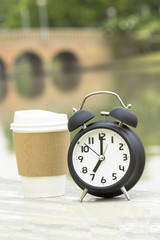 Black Alarm clock and coffee cup