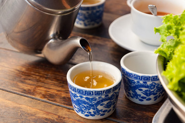 Chinese traditional hot tea pouring from kettle