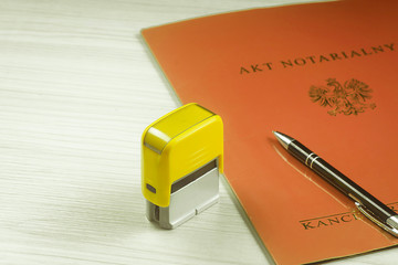 Notarial act with a stamp and a pen