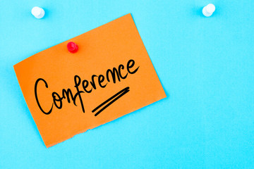 Conference written on orange paper note