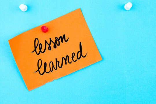 Lesson Learned written on orange paper note