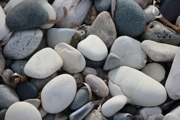 Fototapeta na wymiar Varying Shades of Grey and White Pebbles on Beach in Cyprus.