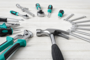 Construction instruments and tools on wooden surface with copy space at the center.