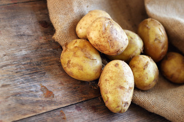 Potatoes on wooden background