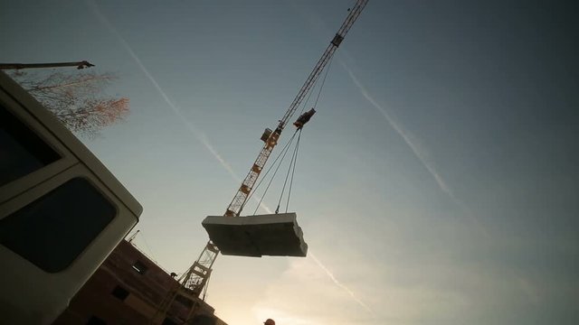 hoisting a concrete slab with crane using metal slings