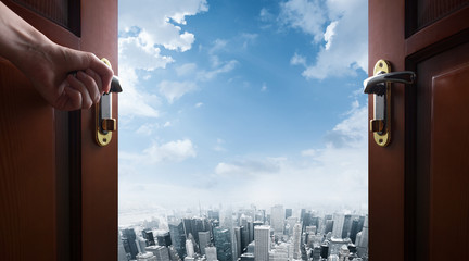 Plakat hand opens room door to the city