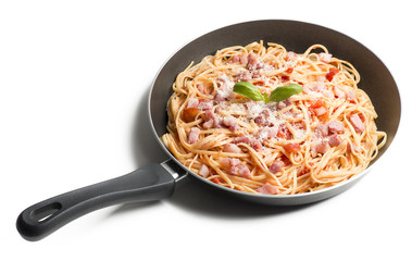 Spaghetti with amatriciana sauce in the pot on the wooden table