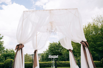 Decorations for the wedding ceremony in the park, Silk tent for the wedding ceremony for the newlyweds