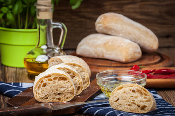 Sliced ciabatta bread on cutting board.