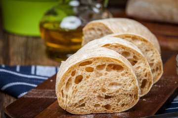 Sliced ciabatta bread on cutting board.