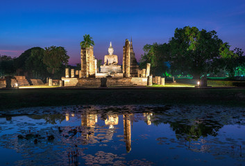 Buddha Statue at Wat Mahathat in Sukhothai Historical Park at twilight time.