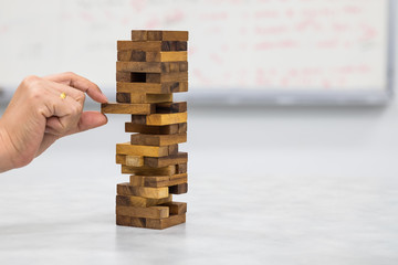 Closeup of  hand playing wood blocks stack game