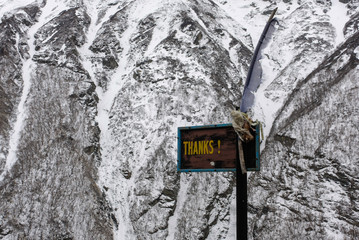 Signboard thanks at path in mountains