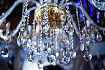 Chrystal chandelier close-up. blue light. Selective focus