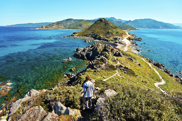 Girl walks down from Genoese Tower of Parata peninsula